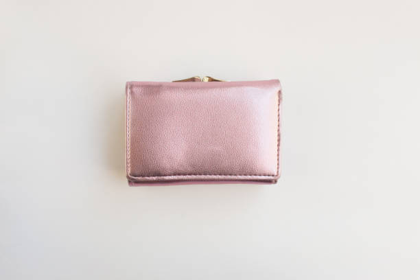 istock metalized pink pastel female wallet on a white background flat layout view reconciliation. Business, finance, money 1222588946