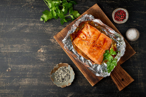Foil pack dinner with fish. Fillet of salmon. Healthy diet food, keto diet stock photo