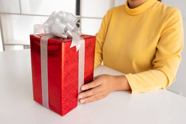 istock the woman holding a giftbox. 1222591074