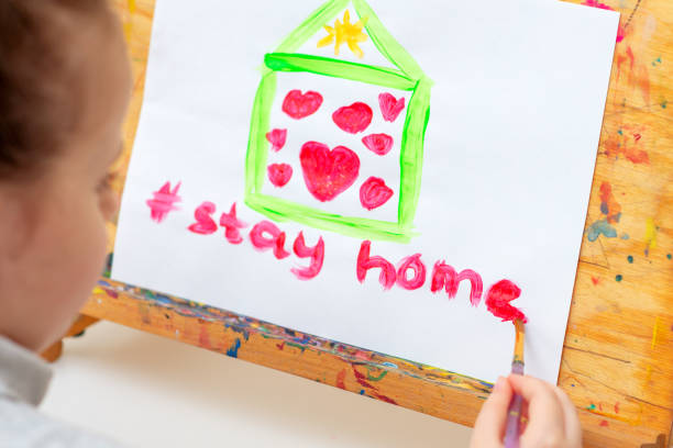 istock Child writes words Stay Home. 1222592520