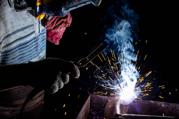 istock welder doing metal work at night, front and background blurred with bokeh effect 1222592579