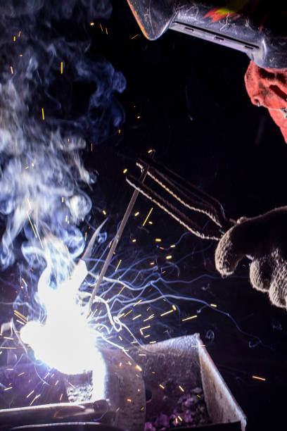 istock welder doing metal work at night, front and background blurred with bokeh effect 1222592583