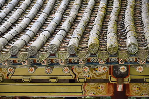 Roof of the Korean traditional house or Hanok in Kaesong. North Korea. Focus on the stone fence