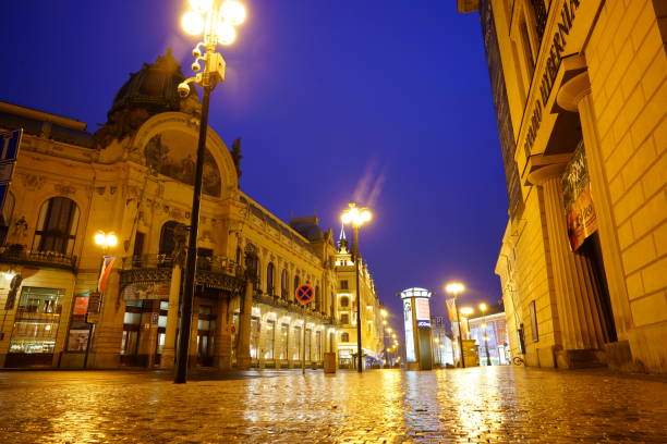 Prague, Czech Republic - January 6, 2016:  The Powder Tower and Municipal House in Prague at Night in the Winter. Cars and Traffic can be seen.