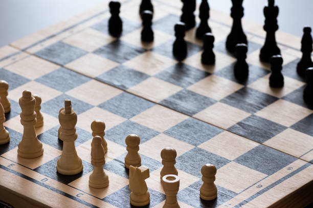 istock Cropped view of chess board with chess pieces on rustic wooden surface 1222596005