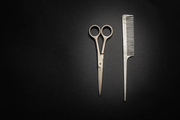 Various hair dresser and cut tools on yellow background with copy space