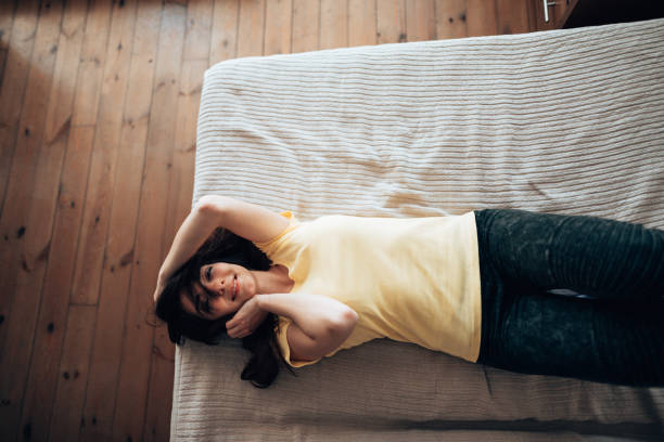 istock woman lying down happiness on the bed 1222600474