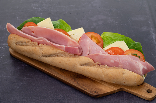 A ham and cheese salad sub sandwich