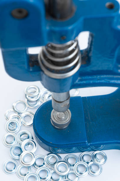 istock Close up hand press eyelet machine and eyelets details 1222603864