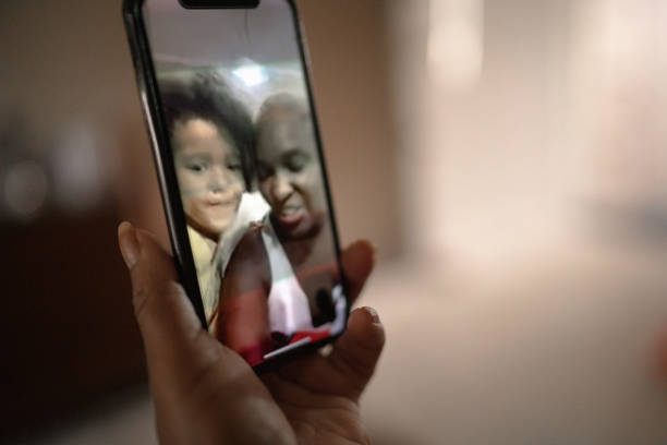 istock Mobile screen with a family on a video chat at home 1222604105