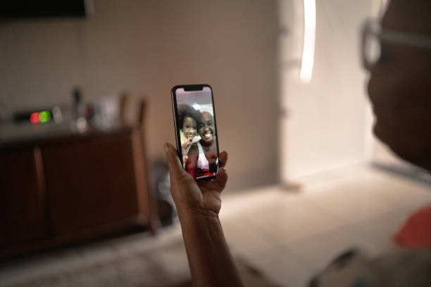 istock Mobile screen with a family on a video chat at home 1222604125