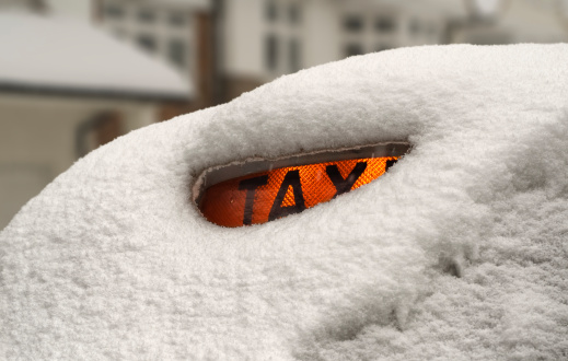An unusual snowfall blocks most London activities. A TAXI cab is covered in snow. February 2009.