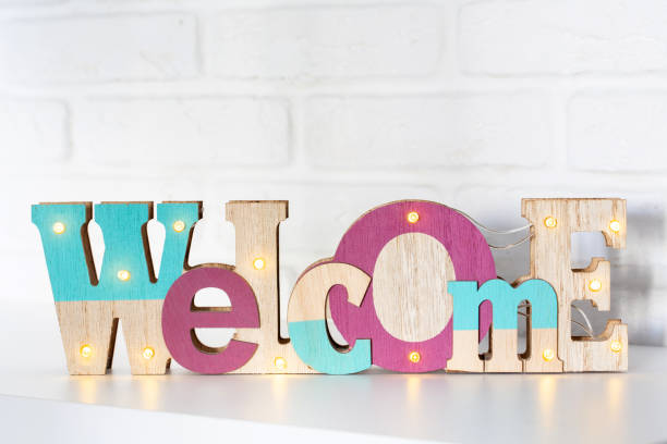 istock Wooden sign with the text welcome on a bright background with copyspace. 1222606588