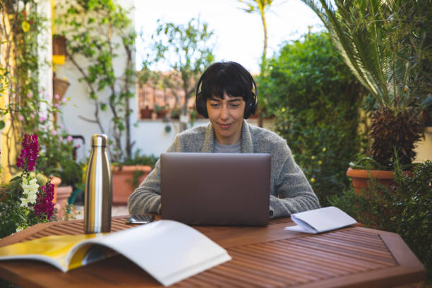 Woman at work from home patio in quarantine lockdown due to Coronavirus