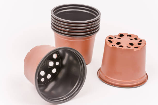 Brand new plastic orange flower pots stock photo