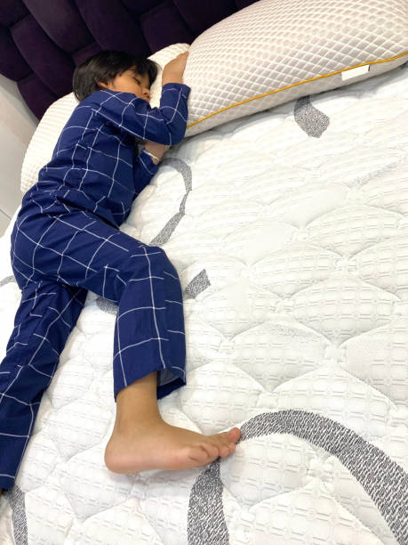 Energetic Young Boy has to face his Bedtime A young boy from India is having difficulty going to sleep at bedtime.  Stated Simply, he just has too much Energy and he wants to extend his Playtime. indian boy barefoot stock pictures, royalty-free photos & images