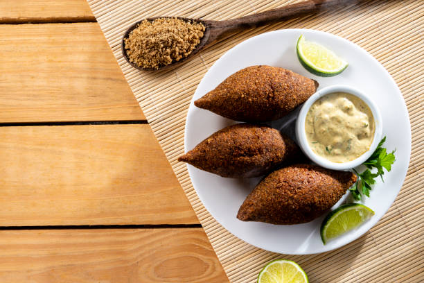 Delicious fried kibbeh served on a  plate on an wooden table, classic recipe. Flat lay Delicious fried kibbeh served on a  plate on an wooden table, classic recipe. Flat lay. middle eastern food photos stock pictures, royalty-free photos & images
