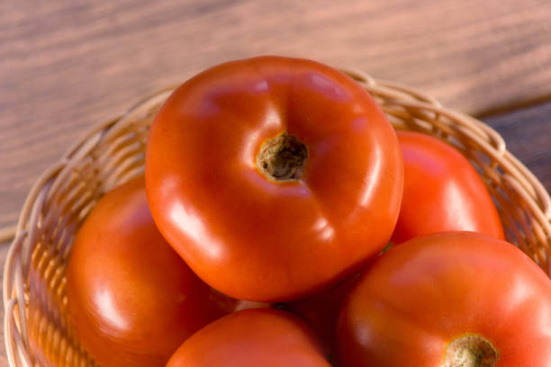 Fresh and ripe juicy tomato slice on white background