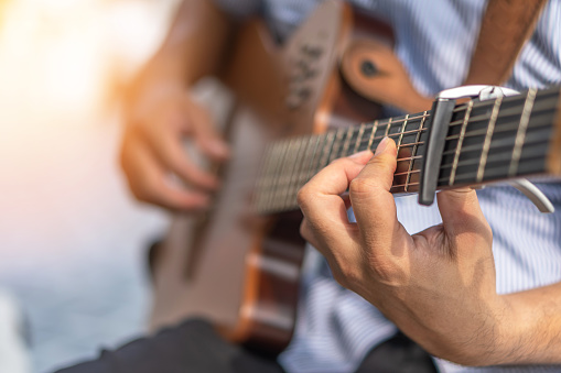 Electric guitar player or guitarlist playing live music show or rehearsal for stag performance or concert