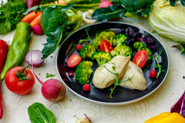 istock Boiled chicken breast with broccoli and tomatoes on a decorated table 1222612423