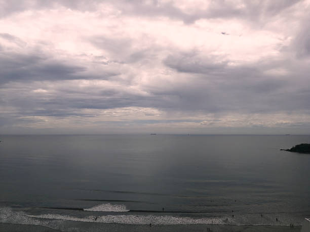 istock Beach coast with grayish sky, boats 1222613408