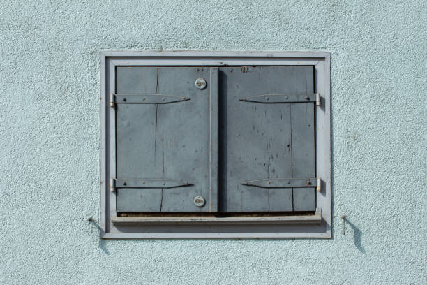 istock Old vintage light blue closed wooden window shutters with 2 safety locks 1222615513