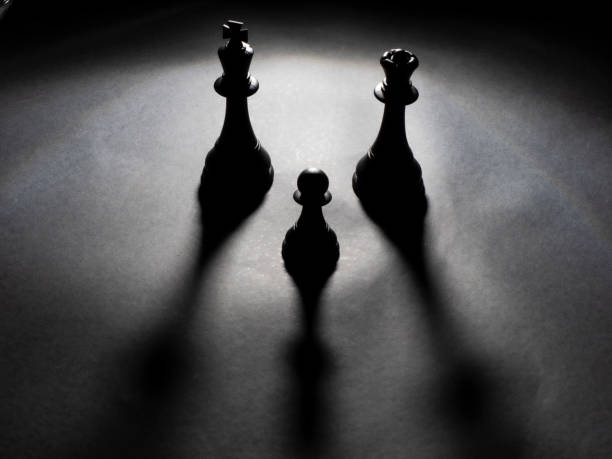 istock Black king and queen chess and a black pawn backlighting 1222615913