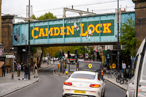 LONDON - SEPTEMBER 30, 2019: The famous Camden Lock bridge on Camden High Street with the painted sign clearly visible
