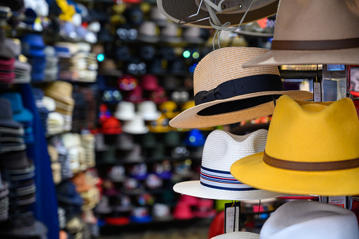 LONDON - SEPTEMBER 30, 2019: Brightly coloured hats for sale at a hat shop in Camden Market