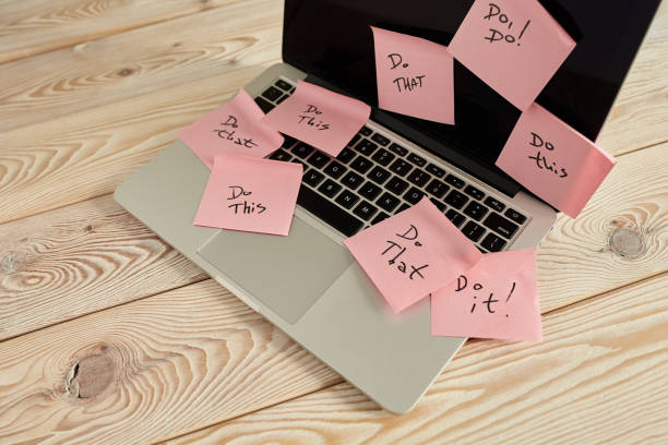 Image of laptop full of sticky notes reminders on screen. Work overload concept image. Coworking or working at home concept image. stock photo