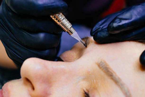 istock master brow artist makes permanent eyebrow makeup in the technique of powder browsers. Semi-permanent make-up 1222617152