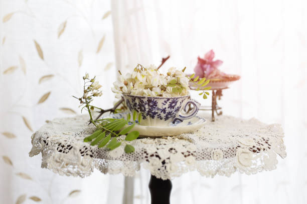 Mother's day, cup of flowers on the table creation of a bouquet of flowers with a cup over the table and baroque lace lacemaking photos stock pictures, royalty-free photos & images