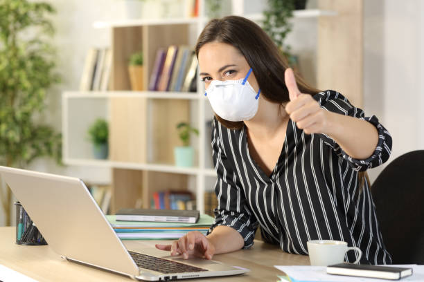 istock Happy freelance with thumbs up working avoiding covid-19 at homeoffice 1222617794