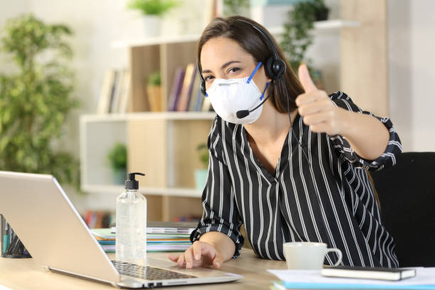 istock Happy telemarketer with thumbs up on covid-19 confinement 1222617823