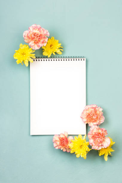 istock Mockup blank notebook with pink and yellow flowers 1222619053