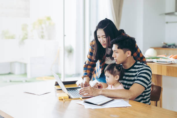 istock Parents with a baby shopping online 1222619224