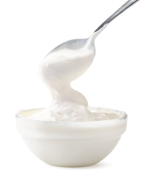istock Sour cream flows from a spoon in a bowl on a white background. Isolated 1222619842