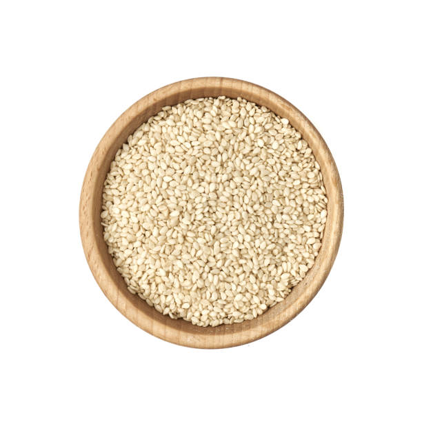 istock Sesame seeds in a small wooden bowl on a white background 1222620640