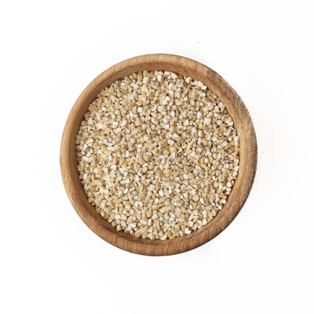istock Barley in a small wooden bowl on a white background 1222620709