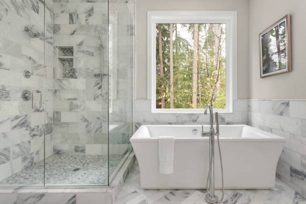 Master Bathroom Interior In Luxury Home With Large Shower With Elegant Tile And Soaking Bathtub Includes Large Window With View Of Trees Stock Photo - Download Image Now - iStock Master Bathroom Interior In Luxury Home With Large Shower With Elegant Tile And Soaking Bathtub Includes Large Window With View Of Trees Stock Photo - Download Image Now - Istock