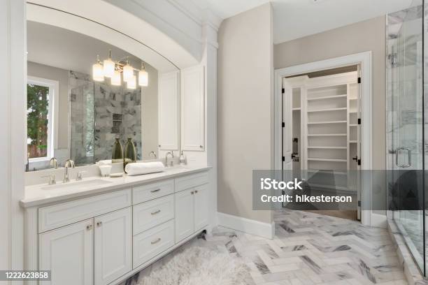 Beautiful Bathroom Interior In New Luxury Home With Vanity Mirror And Cabinets Stock Photo - Download Image Now