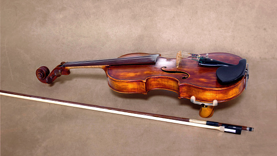 Violin musical instrument orchestra close up isolated on old brown background