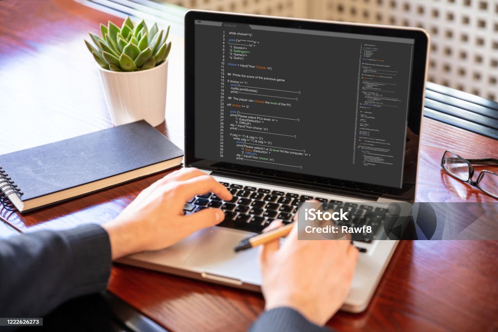 Man Programming On A Computer Office Background Stock Photo - Download ...