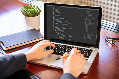Man Programming On A Computer Office Background Stock Photo - Download ...
