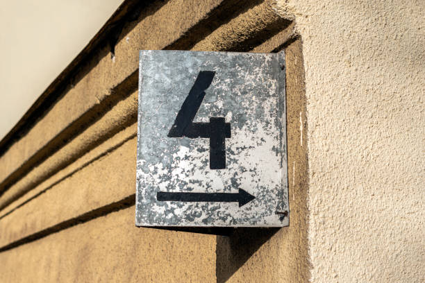 Retro style house number four  hanging on wall.