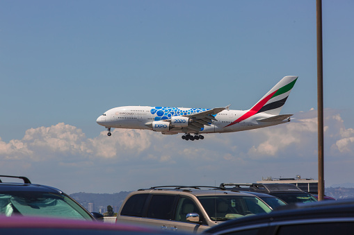 Los Angeles CA - May 24, 2019: An Emirates airplane at LAX airport about to land. Los Angeles International Airport, commonly referred to as LAX, is the primary international airport serving Los Angeles, California, and its surrounding metropolitan area. Busy day at the airport before the summer vacations.