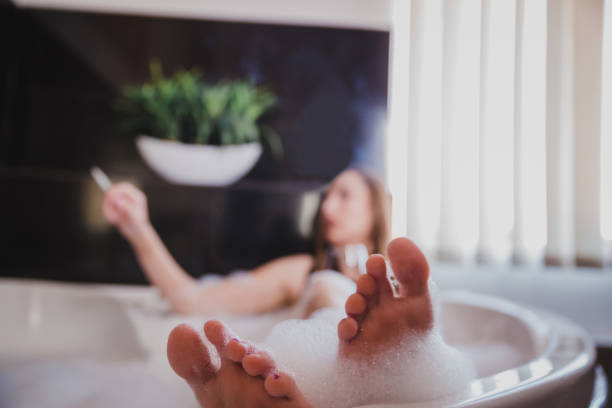 istock Woman smoking a cigarette in bath with foam 1222629221