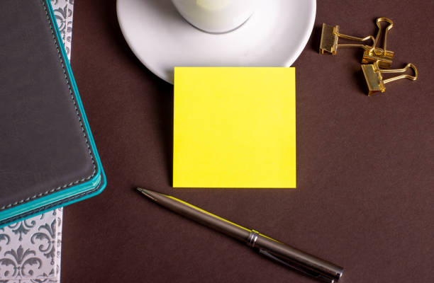Blank paper with pen and coffee cup on wood table