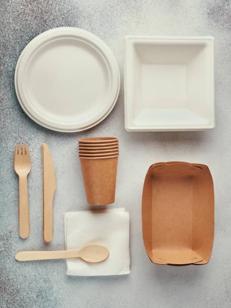 istock Biodegradable disposable tableware. Paper plates, cups, boxes. Wooden cutlery. Flat lay 1222634079
