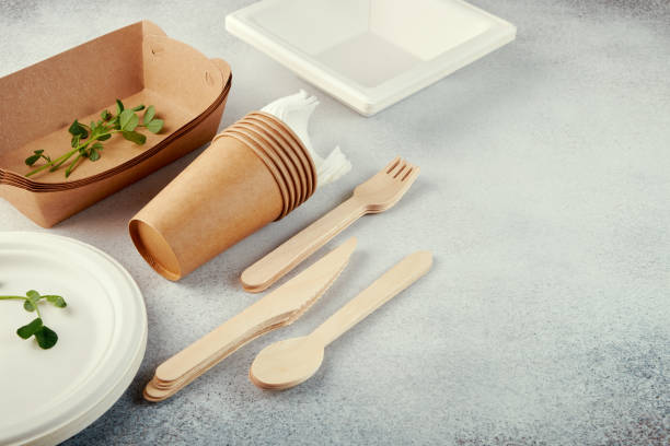 istock Biodegradable disposable tableware. Paper plates, cups, boxes. Wooden cutlery. 1222634083